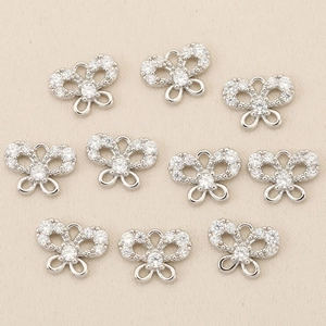 Macro shot of 10 silver butterfly charm connectors with zircon stones for DIY jewelry