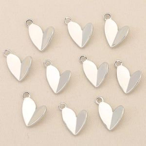 Close-up of heart-shaped 18k gold plated jewelry pendants for DIY necklace making