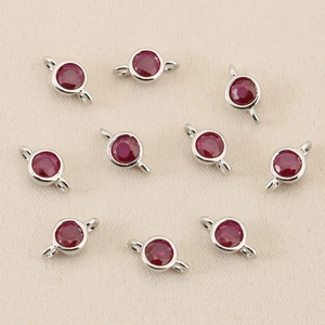 Macro shot of 10 red cubic zirconia connectors with silver plating for DIY jewelry making