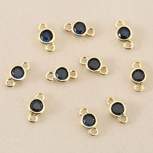 Detail of 18k gold-plated circular connectors with deep blue cubic zirconia for jewelry DIY