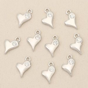 Macro view of 10 heart charms in silver finish with sparkling zircon inlays
