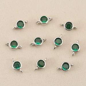 Detail of 10 silver-plated connectors with green cubic zirconia for DIY jewelry making