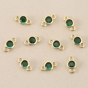 Detailed view of ten 18k gold plated round green zircon double hole connectors for DIY jewelry