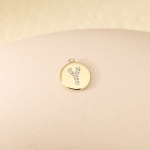 Macro shot of gold-plated letter Y pendant with micro-pave cubic zirconia inlay