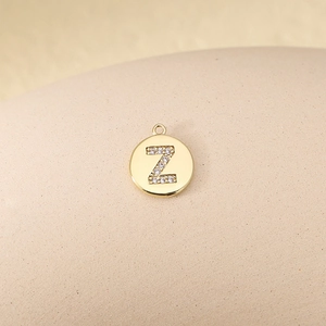 Macro shot of gold plated copper letter Z pendant with micro-pave cubic zirconia inlay