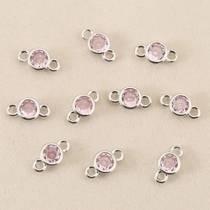 Close-up of silver-plated copper connectors with pink zircons for DIY jewelry making