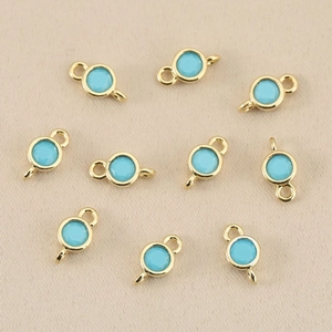 Detailed macro view of 18k gold plated double-loop sky blue birthstone jewelry connectors