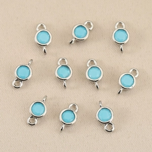 Detailed view of silver finish 18k gold-plated sky blue birthstone charm connectors
