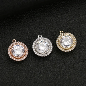 Three round gold-plated pendants with halo crystals and zircon in various metal colors