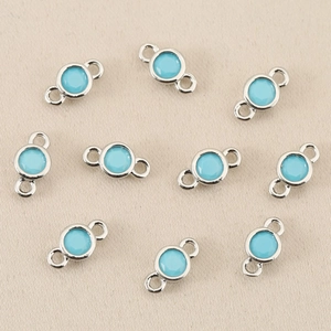 Detail view of 10 silver-plated round connectors with light blue zircons for DIY jewelry