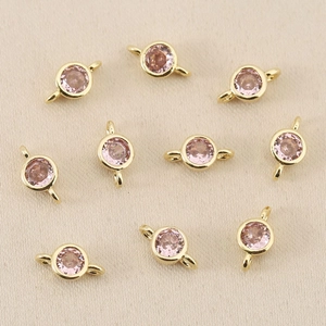 Detail of 18k gold plated round link connectors with pink zircon for DIY jewelry making