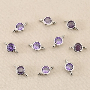 Macro shot of ten purple round zircon pendants with 18k gold-plated silver connectors