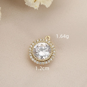 Gold-plated round jewelry pendant with sparkling cubic zirconia center and halo stones