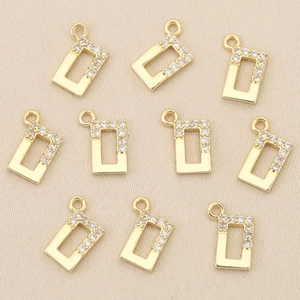 Macro shot of rectangular 18k gold plated charms with white cubic zirconia inlay