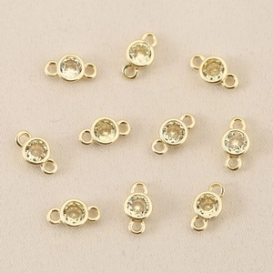Close-up of 10 gold plated 18k copper connectors with champagne zircon for jewelry DIY