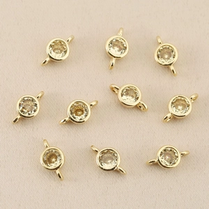Macro view of 18k gold-plated double-loop jewelry connectors with sparkling zircons