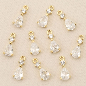 Macro detail of teardrop zircon charms with 18k gold plating for DIY jewelry making