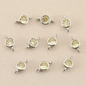 Macro view of 10 silver plated circular zircon pendants for DIY jewelry connector making
