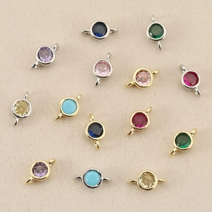 Detailed view of colorful round zircon connectors in 18k gold and silver plated frames