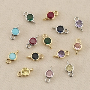 Macro shot of colorful faceted birthstone charms with dual gold or silver plated connectors