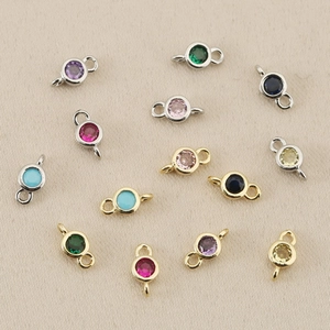 Close-up of 18k gold plated birthstone connector charms in various vibrant colors