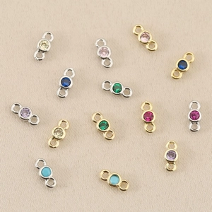 Detailed macro view of 18k gold-plated CZ colorful connector charms for DIY jewelry making