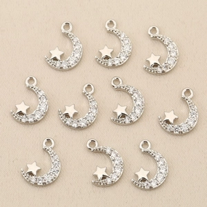 Detailed view of ten sparkling silver moon and star charms for DIY jewelry making