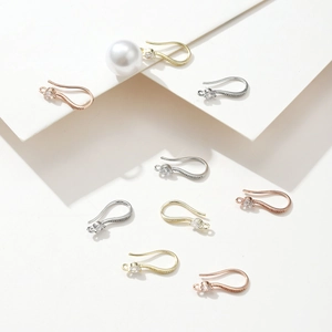Detail of 18k gold plated earring hooks with cubic zirconia and a large white pearl