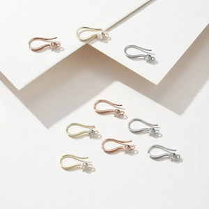Macro detail of 18K gold plated earring hooks with cubic zirconia and DIY rings
