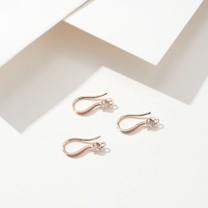 Detail of 18k rose gold plated earring hooks with sparkling zircon for DIY jewelry making