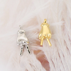 Macro shot of 18K gold and silver plated hand gesture pendants with fine polishing
