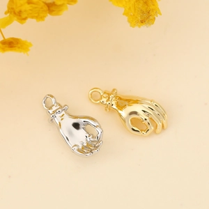 Detail of hand gesture charms in gold and silver finish for DIY jewelry making