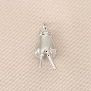 Close-up of a polished silver V-gesture charm with a bail for necklace or bracelet