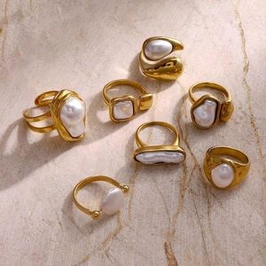 Macro view of Baroque pearl rings collection in gold-plated stainless steel on stone