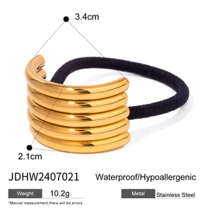 Golden five-layer stainless steel hair tie cuff with black elastic band on white background