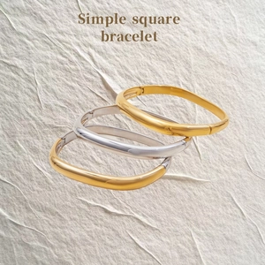 Minimalist square stainless steel bangles in gold and silver with a polished finish