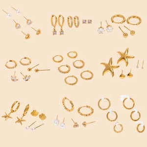 Set of nine gold-plated stainless steel earrings with pearls, zircons, and sea shells