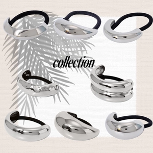 Nine geometric polished silver metal hair ties with black elastic bands on a beige background