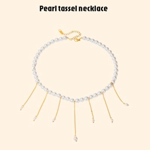 Elegant white pearl necklace featuring gold tassel pendants and an adjustable lobster clasp
