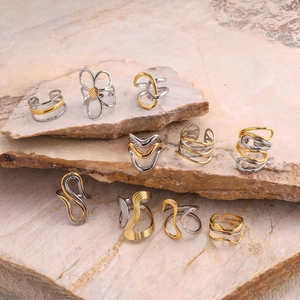Two-tone stainless steel rings with minimalist wavy and floral designs on pink stone
