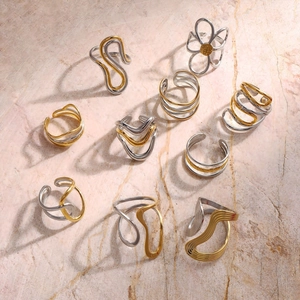Macro view of bicolor stainless steel rings with irregular geometric and wave shapes