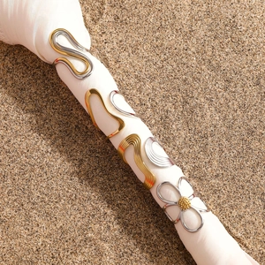 Minimalist gold and silver two-tone stainless steel rings with sleek wavy line designs