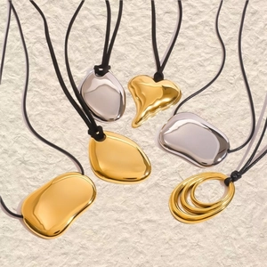 Minimalist black cord necklaces with polished gold and silver organic shape pendants