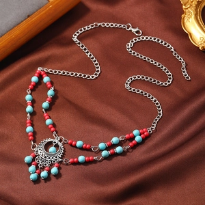 Bohemian forehead chain with turquoise beads and intricate ethnic metal tassel pendant