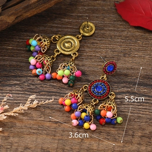 Bohemian vintage tassel earrings with colorful beads and turquoise-like center stones
