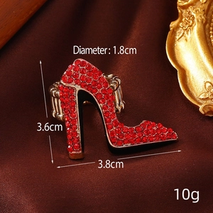 Vintage gold ring with red rhinestone high heel design on elegant silk background