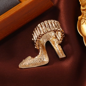 Retro gold stiletto high heel ring with elastic stretch band on silk background