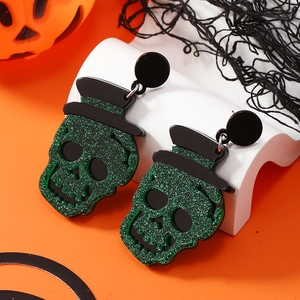 Halloween schedel oorbellen met zwarte hoed en groene lovertjes op oranje achter
