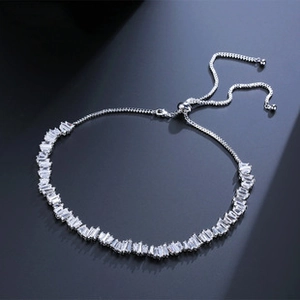 Macro shot of silver baguette-cut zircon slider bracelet with adjustable bead closure