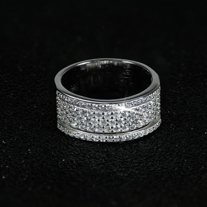 Foto macro de anillo plateado con tres filas de circonitas 3A brillantes engastadas